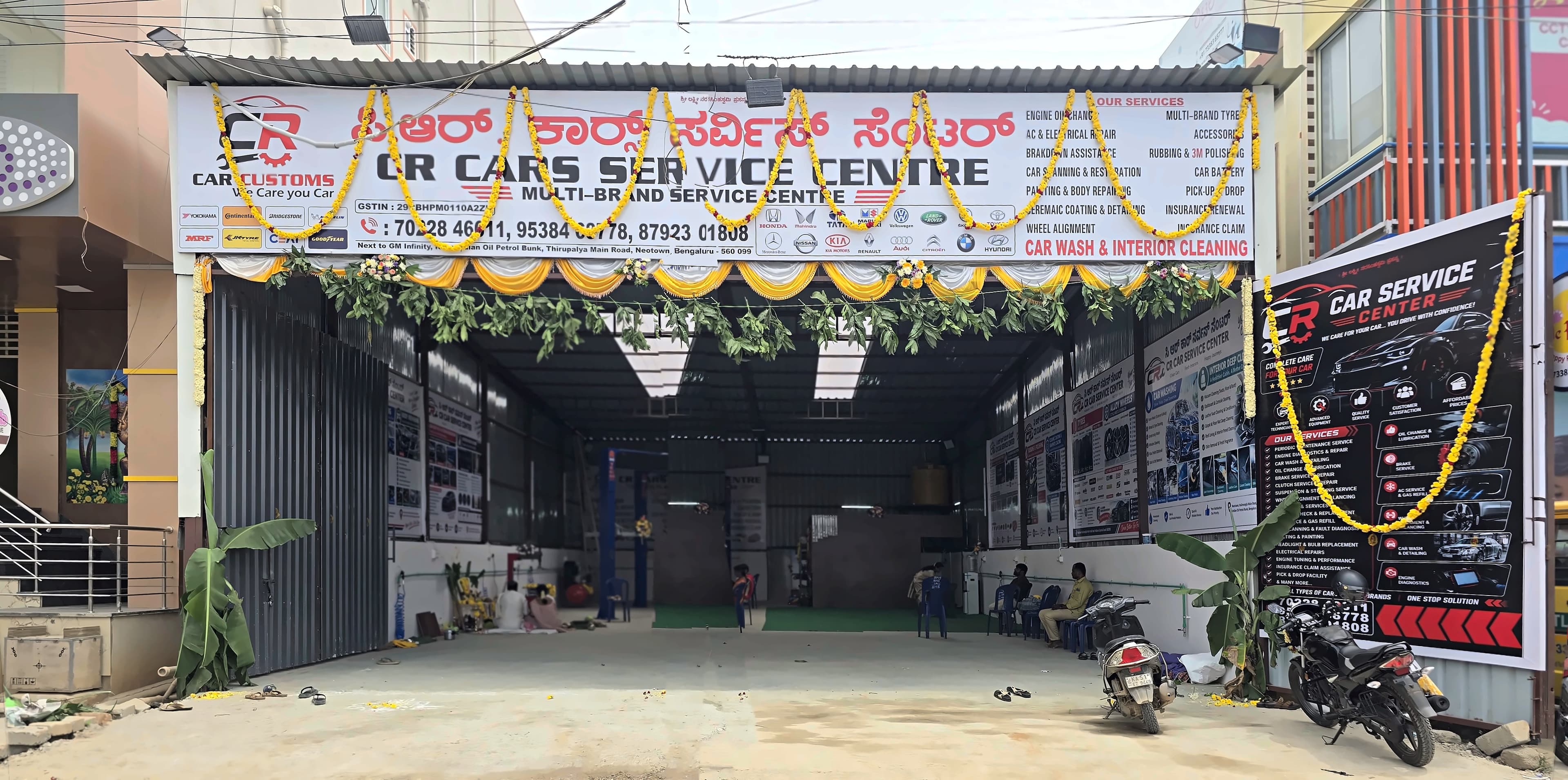 The CR Cars Service Centre frontage on Thirupalya Main Road, its open service bay decorated with marigold garlands