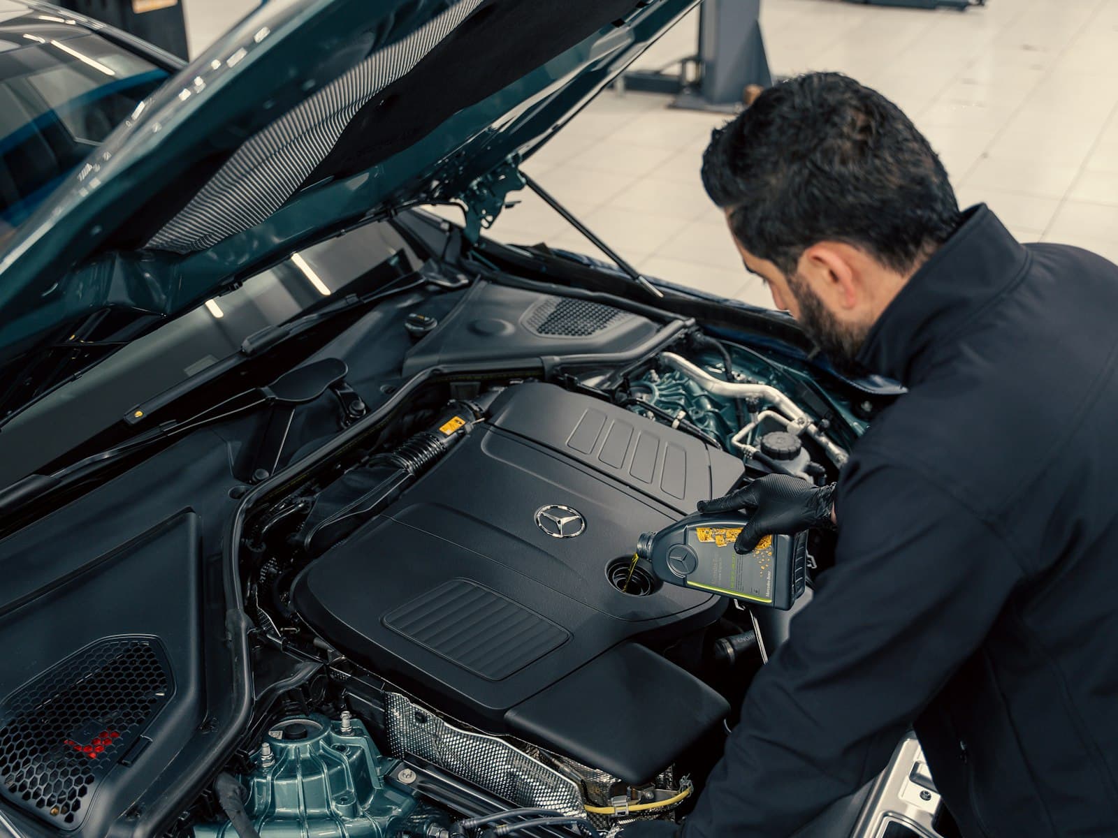 A technician working on an engine in a bright workshop