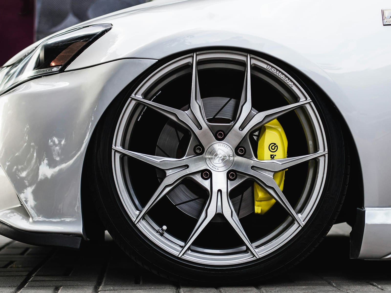 An alloy wheel with a yellow brake caliper behind it