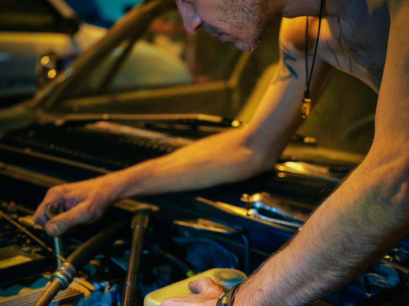 Close-up of hands working on an engine