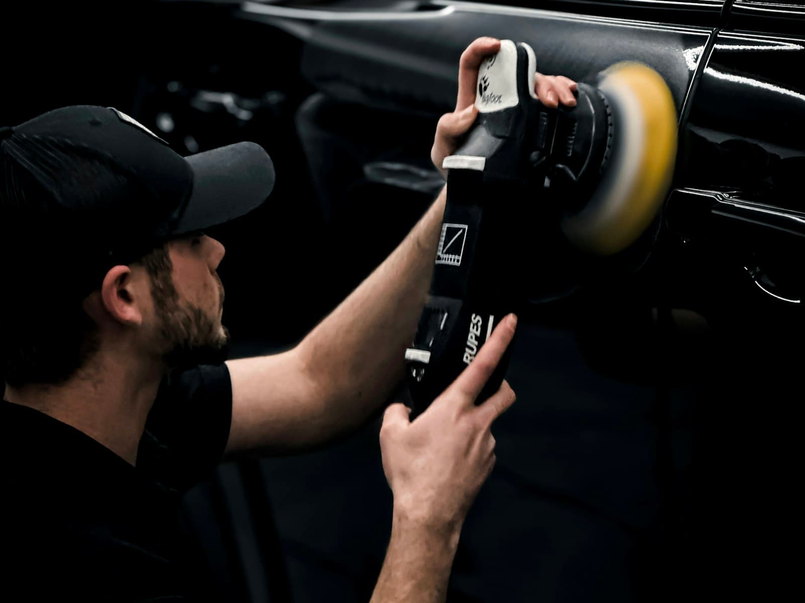 A machine polisher being used on bodywork